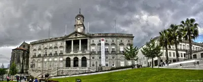 a large building with a clock tower on top of it at Guest House Triunfo in Porto