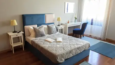 a bedroom with a bed with two books on it at Cool Guesthouse in Porto