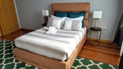 a bedroom with a large bed with blue and white pillows at Cool Guesthouse in Porto