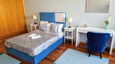 a bedroom with a blue bed and a desk at Cool Guesthouse in Porto