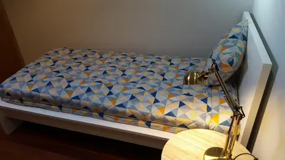 a small bed in a room with a table at Cool Guesthouse in Porto