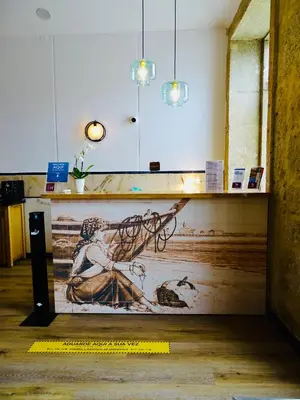 a wall with a painting of a woman on it at Poveira Hotel in Porto