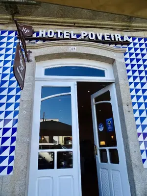 a door to a hotel room with a sign above it at Poveira Hotel in Porto