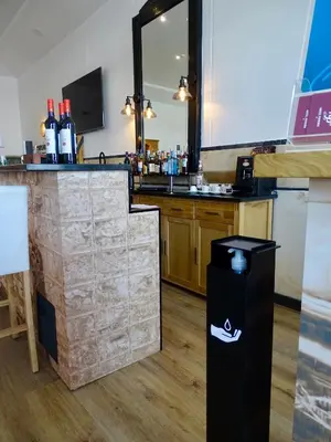 a bar with a counter and a trash can at Poveira Hotel in Porto