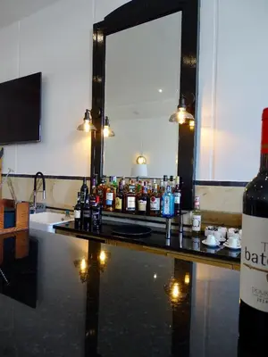 a bar with bottles of alcohol on a counter at Poveira Hotel in Porto