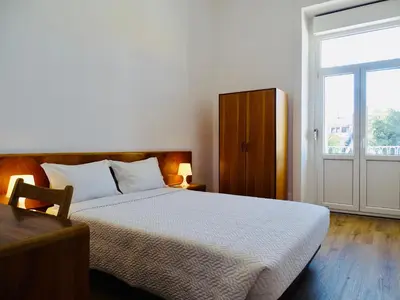 a bedroom with a bed and a large window at Poveira Hotel in Porto