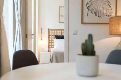 a room with a mirror and a table and a cactus at Light Blue Apartment in Porto