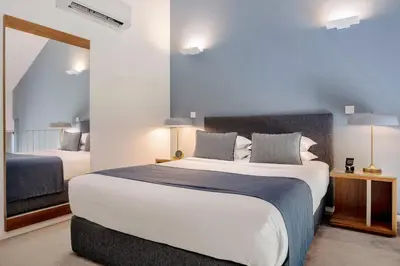 a bedroom with a large bed and a mirror at UMA Santa Catarina - Pool & Fitness, Adults Only in Porto
