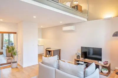 a living room with a couch and a tv at UMA Santa Catarina - Pool & Fitness, Adults Only in Porto