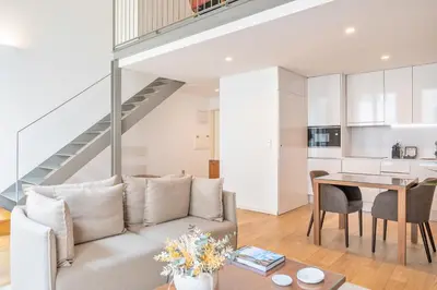 a living room with a couch and a table at UMA Santa Catarina - Pool & Fitness, Adults Only in Porto