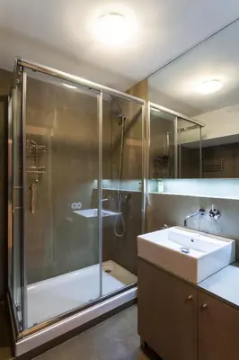 a bathroom with a glass shower and a sink at Loft Ribeira - 3px - Spacious Flat in Porto