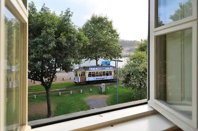 a window with a view of a trolley at FLH Oporto Captain House in Porto