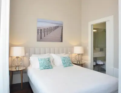 a living room with a white couch and a bed at YOUROPO - Market in Porto