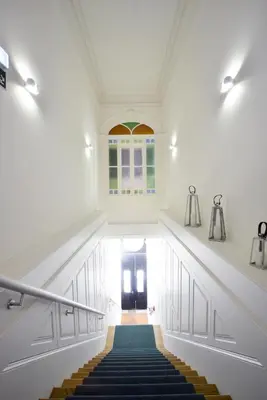 a hallway with stairs and a window and a door at YOUROPO - Market in Porto