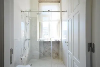 a white bathroom with a shower and a window at YOUROPO - Market in Porto