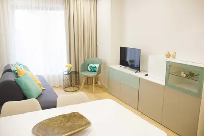 a living room with a couch and a tv at MH Duo in Porto