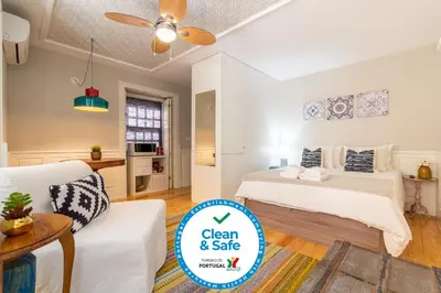 a bedroom with two beds and a living room with a couch at Best Of Porto Apartment - BOP in Porto