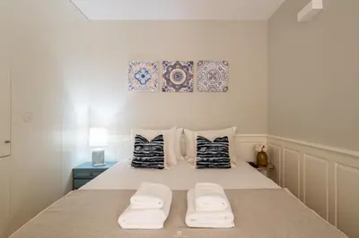 a bedroom with a bed with two towels on it at Best Of Porto Apartment - BOP in Porto