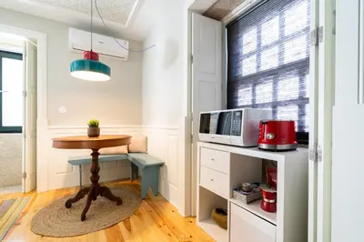 a small kitchen with a table and a microwave at Best Of Porto Apartment - BOP in Porto
