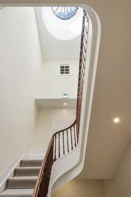 a spiral staircase in a building with a skylight at FAISAMA • Porto Apartments in Porto