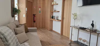 a living room with a couch and a fire extinguisher at Alma Invicta Alegria in Porto