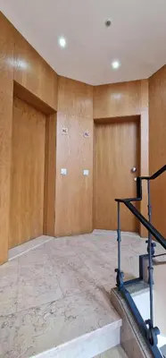 a room with wooden walls and a staircase and two doors at Alma Invicta Alegria in Porto