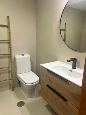 a bathroom with a toilet and a sink and a mirror at Maestro Appartment in Porto