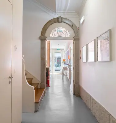 a bathroom with two sinks and a large mirror at Porto Lounge Hostel & Guesthouse by Host Wise in Porto