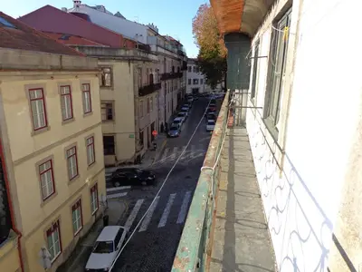 a view of a street from a balcony of a building at A Portuguesa Guest House in Porto