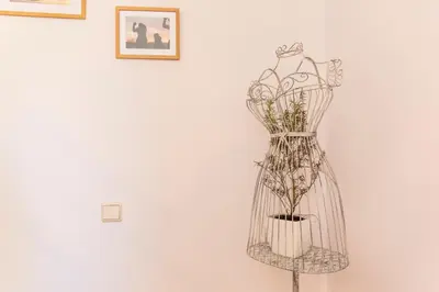 a statue of a dress on a wall at Sunset Relaxing Apt with terrace, parking & bikes in Porto