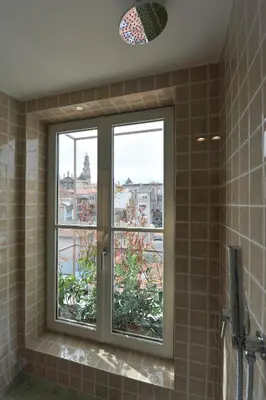 a bathroom with a window with a view of a city at Oporto AAA - Almada Aliados Apartment in Porto