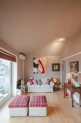 a living room with a white couch and a window at Oporto AAA - Almada Aliados Apartment in Porto