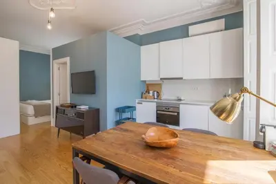 a kitchen with a table with a bowl on top of it at Central location with garden & equipped kitchen in Porto