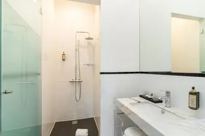 a bathroom with a shower and a toilet and a sink at Marquês Garden House by Olivia in Porto