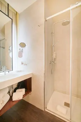 a bathroom with a shower and a sink at Hotel Moon & Sun Porto in Porto