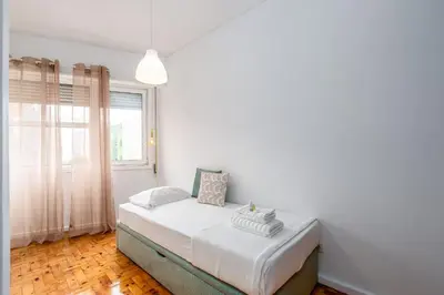 a bedroom with a bed in a room with a window at OPO Bolhao Flats by Destiny Houses in Porto