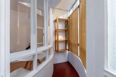 a hallway with windows and a red floor at OPO Bolhao Flats by Destiny Houses in Porto