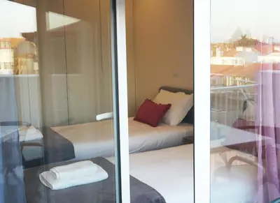 two views of a room with a bed and a window at OPO Bolhao Flats by Destiny Houses in Porto