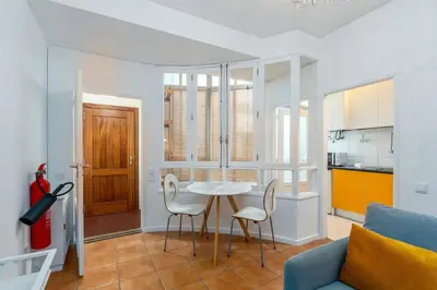 a kitchen and a living room with a table and chairs at OPO Bolhao Flats by Destiny Houses in Porto