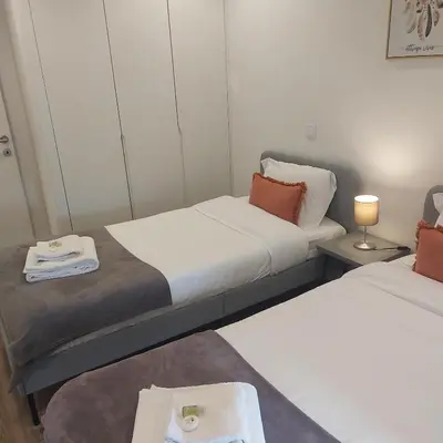a room with two beds and a table in it at OPO Bolhao Flats by Destiny Houses in Porto