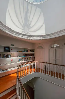 a staircase in a house with white walls and wooden floors at Rosa Et Al Townhouse in Porto