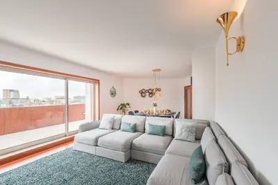 a living room with a couch and a large window at GuestReady - Jazz Apartment in Porto