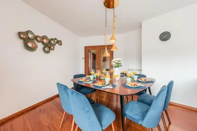 a dining room with a table and blue chairs at GuestReady - Jazz Apartment in Porto