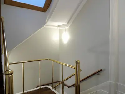 a set of stairs with a light on the ceiling at Cool Terrace Apartment in Porto