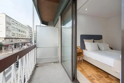 a bedroom with a bed on a balcony at Bruno's Downtown Apartment in Porto