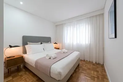 a bedroom with a bed with two stuffed animals on it at Bruno's Downtown Apartment in Porto