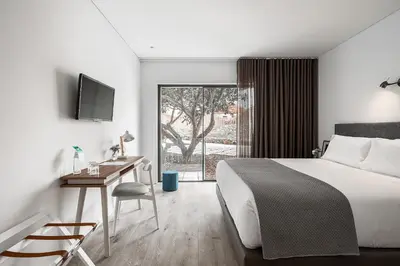 a hotel room with a bed and a desk and a window at Caléway Hotel in Vila Nova de Gaia