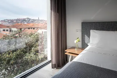 a bedroom with a bed and a window with a view at Caléway Hotel in Vila Nova de Gaia
