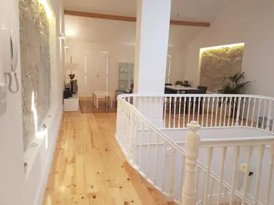 a white staircase in a room with a wooden floor at Oporto City View - Wonderful Apartment in Porto
