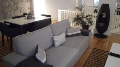 a living room with a gray couch and a table at Oporto City View - Wonderful Apartment in Porto
